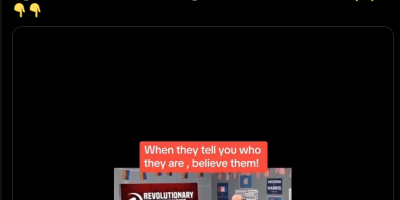 front of a communist poster 